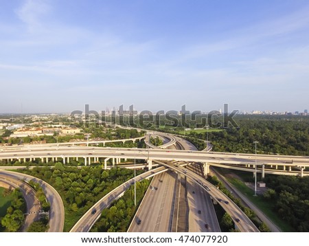 Aerial view interstate 10, Katy freeway and downtown with massive intersection, stack interchange and elevated road junction overpass at late afternoon from the west side of Houston, Texas, USA.