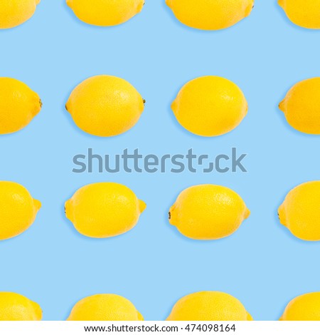 Seamless pattern of fresh yellow lemon on blue background