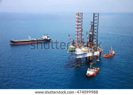 Aerial View of Offshore Jack Up Drilling Rig in The Middle of The Ocean:Selective focus with shallow depth field.

