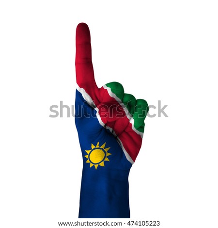 Hand pointing thumb up direction, namibia painted with flag as symbol of up direction, first and number one symbol - isolated on white background