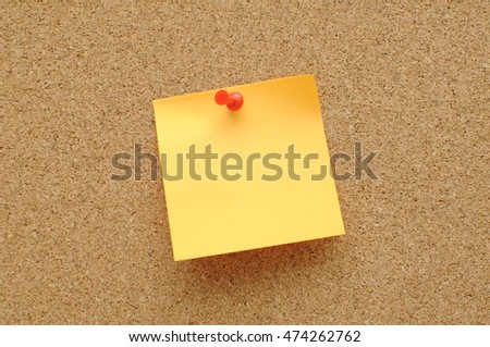  orange sticky notes with push pin on cork broad