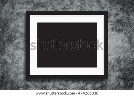 Black photo frame on concreate wall background for design pattern artwork. 