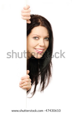 Beautiful young woman with long hair holding white board vertically and  peeping round the corner,isolated on white