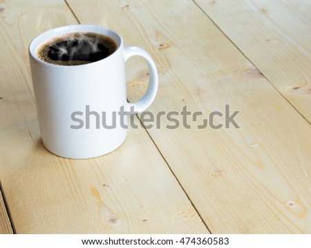 White hot mug or coffee cup with stream on wood table Royalty-Free Stock Photo #474360583
