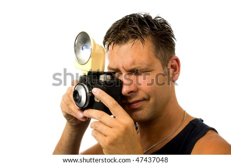 man is taking pictures with old fashioned photo camera over white background