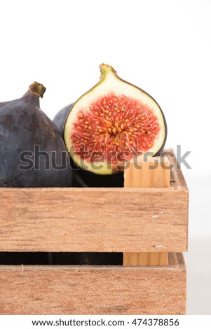Macro shot of a half sliced fig fruit in on white background. Focus on half sliced fig.
