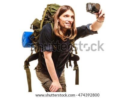 Man tourist backpacker on trip taking photo picture with camera. Young guy hiker backpacking. Summer vacation travel. Isolated on white background.