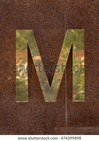 
gold letters on a granite background