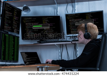 Boy Listening To Music While Stealing Data From Multiple Computers