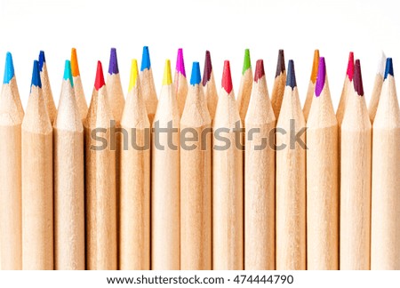 Different natural colored pencils on white background. Shallow depth of field.