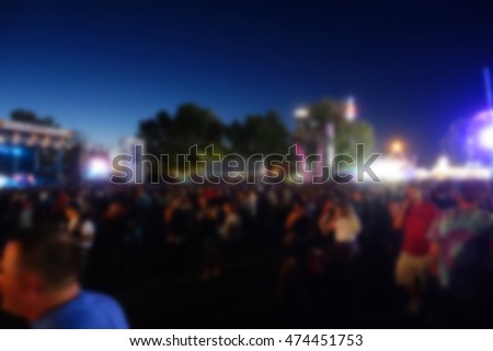 blur background of people at county fair at night                            
