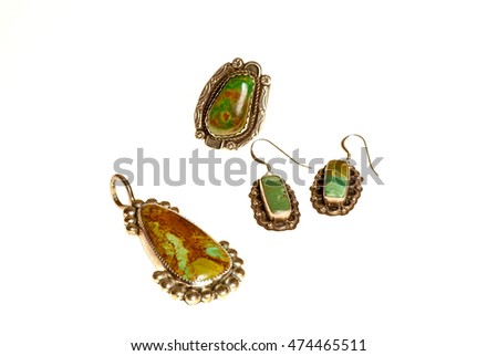 Set of green turquoise jewelry -- pendant, ring and earrings isolated on white background.  All handcrafted pieces by Native American Artisans.