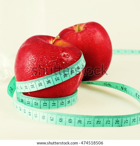 two red wet apples and measurement, square toned image
