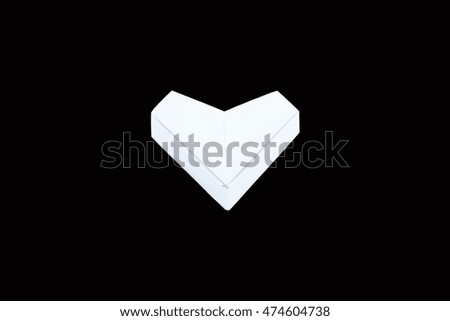 Heart shaped paper isolated on black