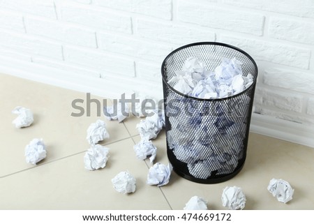Office trashcan with crumpled paper balls 