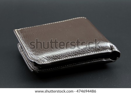 Stylish mens leather wallet brown leather on black background