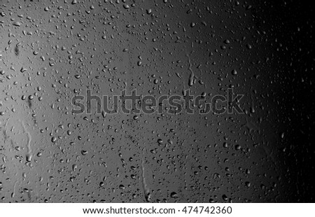 Raindrops on the window on the dark background
