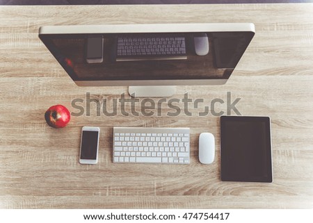 Top view of modern computer, digital tablet and smartphone for business people working in office, on wooden table
