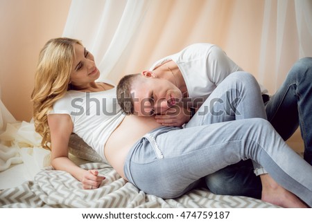 Young pregnant woman and her husband. Waiting for baby