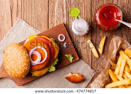 Delicious fish burgerserved with fresh french fries. 