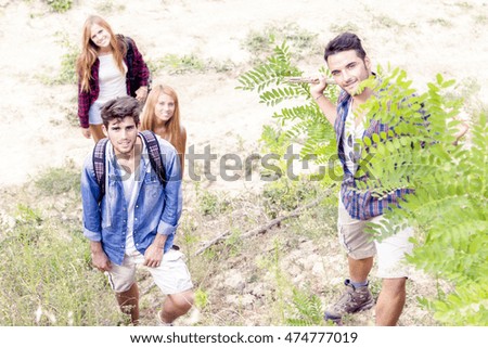 group of young hikers walking over the mountain