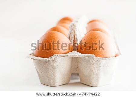 full carton of brown eggs on a white background.