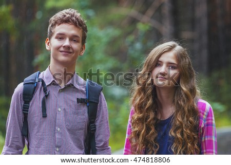 Portrait of happy teenage couple  outdoors in the park.