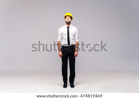 Thinking about solution. Full length studio shot of thoughtful young man in hardhat looking up