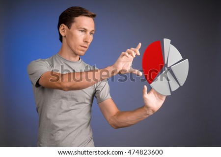 Man in t-shirt working with pie chart on blue background.