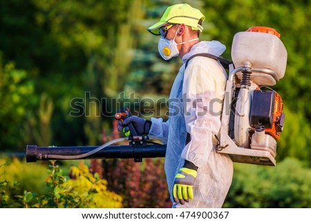 Garden Pest Control Services. Men with Gasoline Pest Control Spraying Equipment. Professional Gardening Royalty-Free Stock Photo #474900367