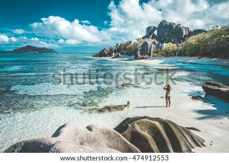 A woman taking pictures of the most beautiful beach of Seychelles - Anse Source D'Argent