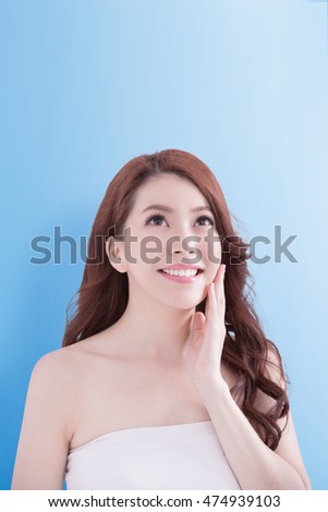 beauty woman smile and look copy space happily with isolated blue background, asian