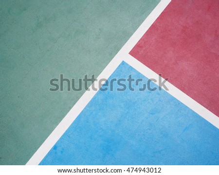 White line on colorful concrete floor of outdoor basketball court.
