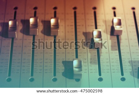 Professional audio studio sound mixer equipment console faders background Royalty-Free Stock Photo #475002598