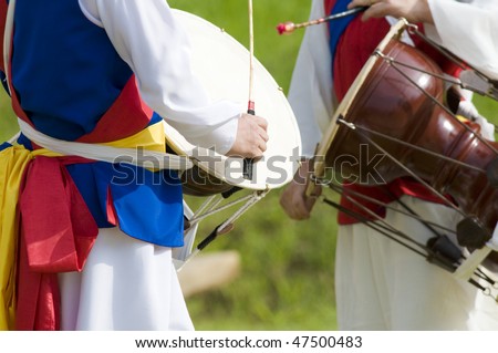 Two Korean drummers playing the traditional hourglass-shaped drum (janggu). Royalty-Free Stock Photo #47500483