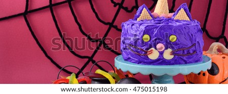 Happy Halloween cat cake party food with purple frosting, sized to fit a popular social media cover image placeholder.