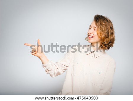 beautiful girl mocking of you, close-up, isolated on a gray background