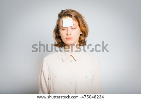 beautiful girl with a sticker on the forehead, close-up, isolated on a gray background
