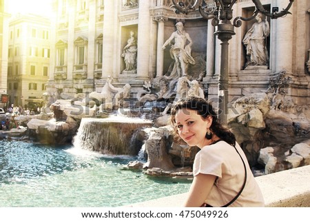 A beautiful young woman getting rest near Trevi fountain, Rome. Vintage style picture