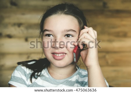 Little teen girl calling by phone