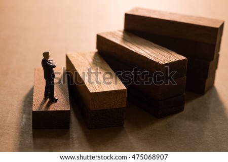  Successive business concept.Businessmen thinking on first step of wood stair. Royalty-Free Stock Photo #475068907