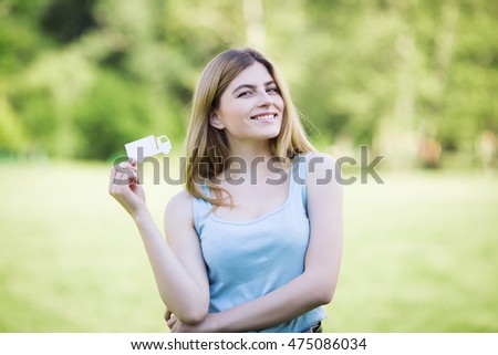 Young girl holding cardboard figure of truck