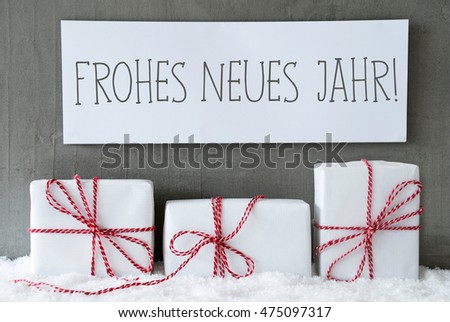 Label With German Text Frohes Neues Jahr Means Happy New Year. Three Christmas Gifts Or Presents On Snow. Cement Wall As Background. Modern And Urban Style.