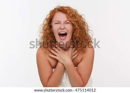 Picture of screaming or shouting mature woman isolated on white. Red haired woman posing for photographer in studio. Expressing emotions concept.