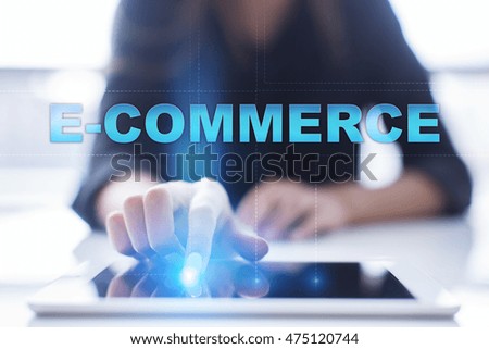 Woman is using tablet pc, pressing on virtual screen and select "E-commerce".