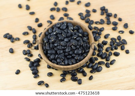 Black beans on wooden background