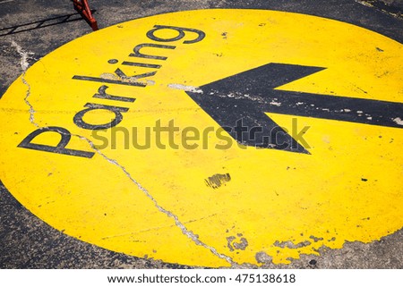 Parking sign with arrow on the cement floor