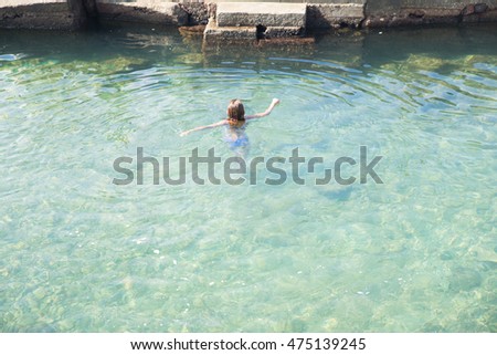 Girl swimming at the sea