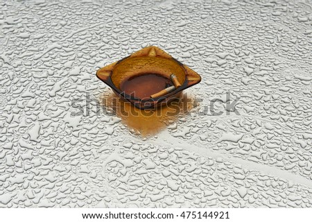 ashtray on a wet table
