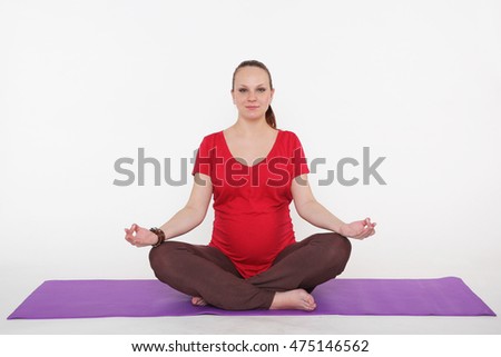 pregnant woman is doing yoga and meditating